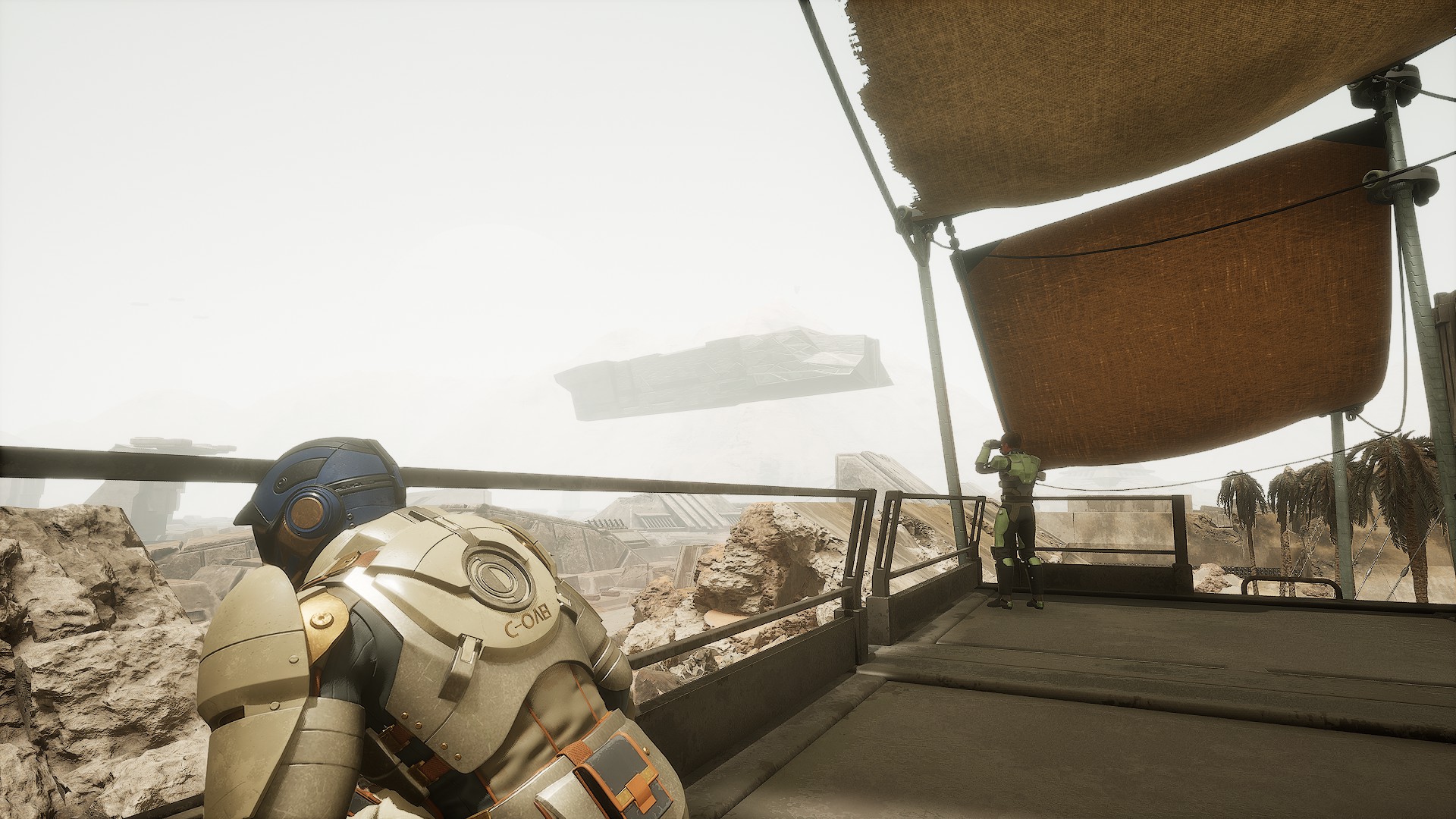 Two armoured characters stand on a balcony beneath fabric shades, overlooking a hazy desert settlement.