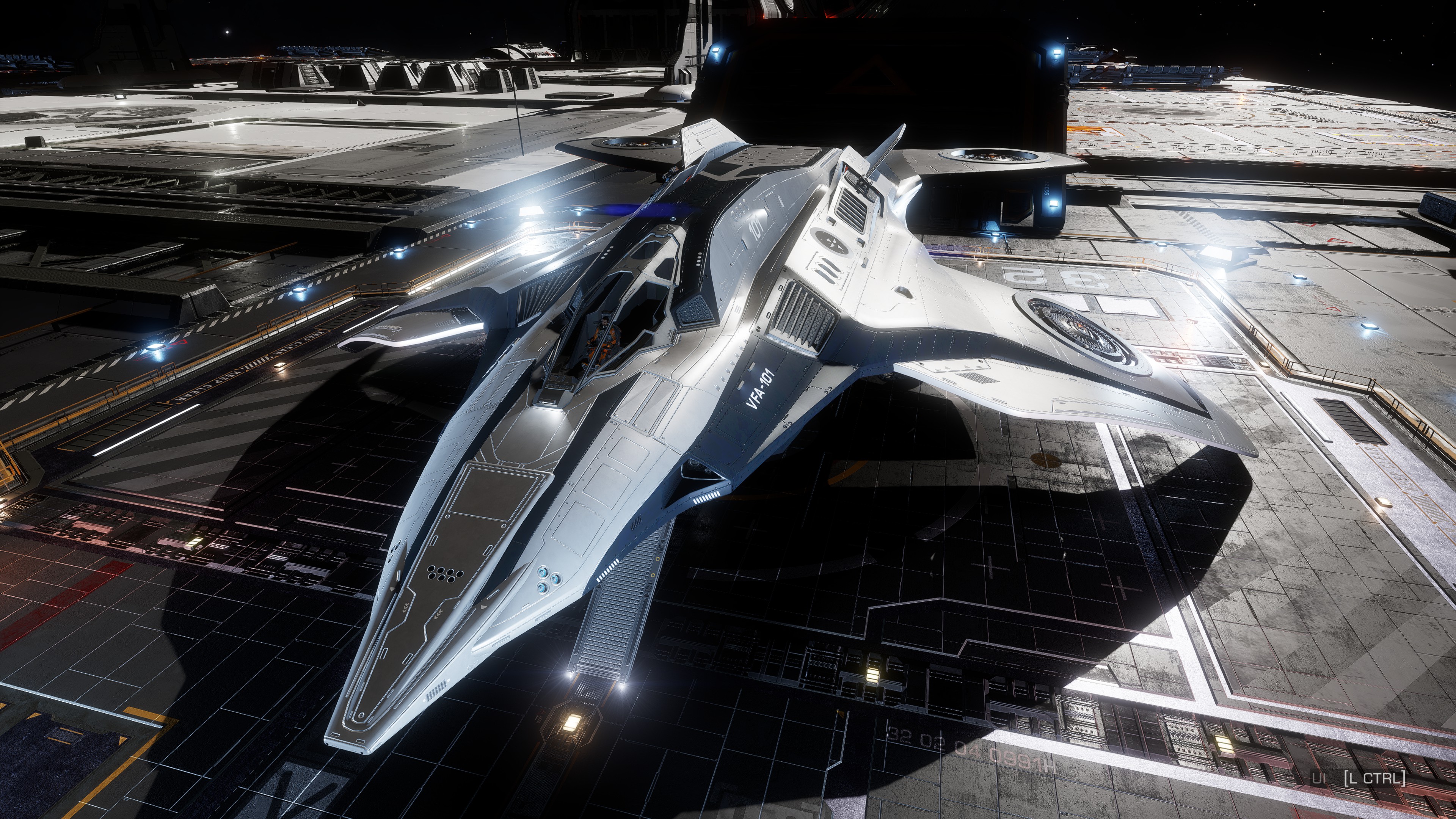 Jackaroos spacecraft parked on a brightly lit carrier flight deck in Elite Dangerous.