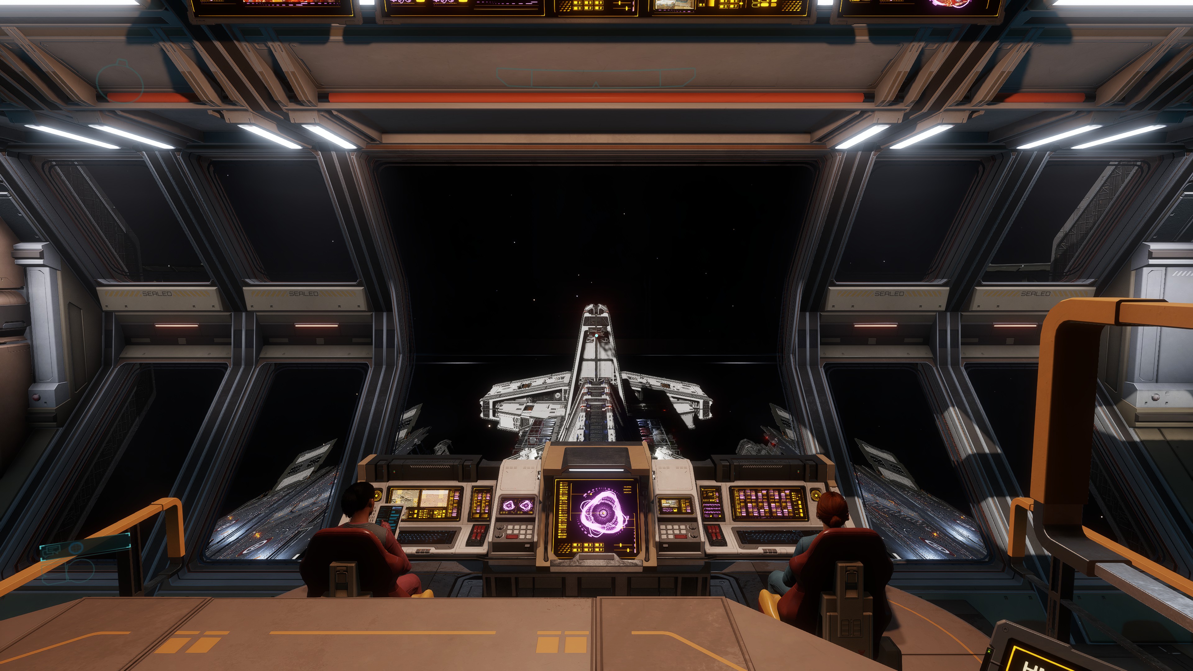 Two crew members at illuminated bridge consoles, looking through a wide viewport toward the ship’s forward deck and space.