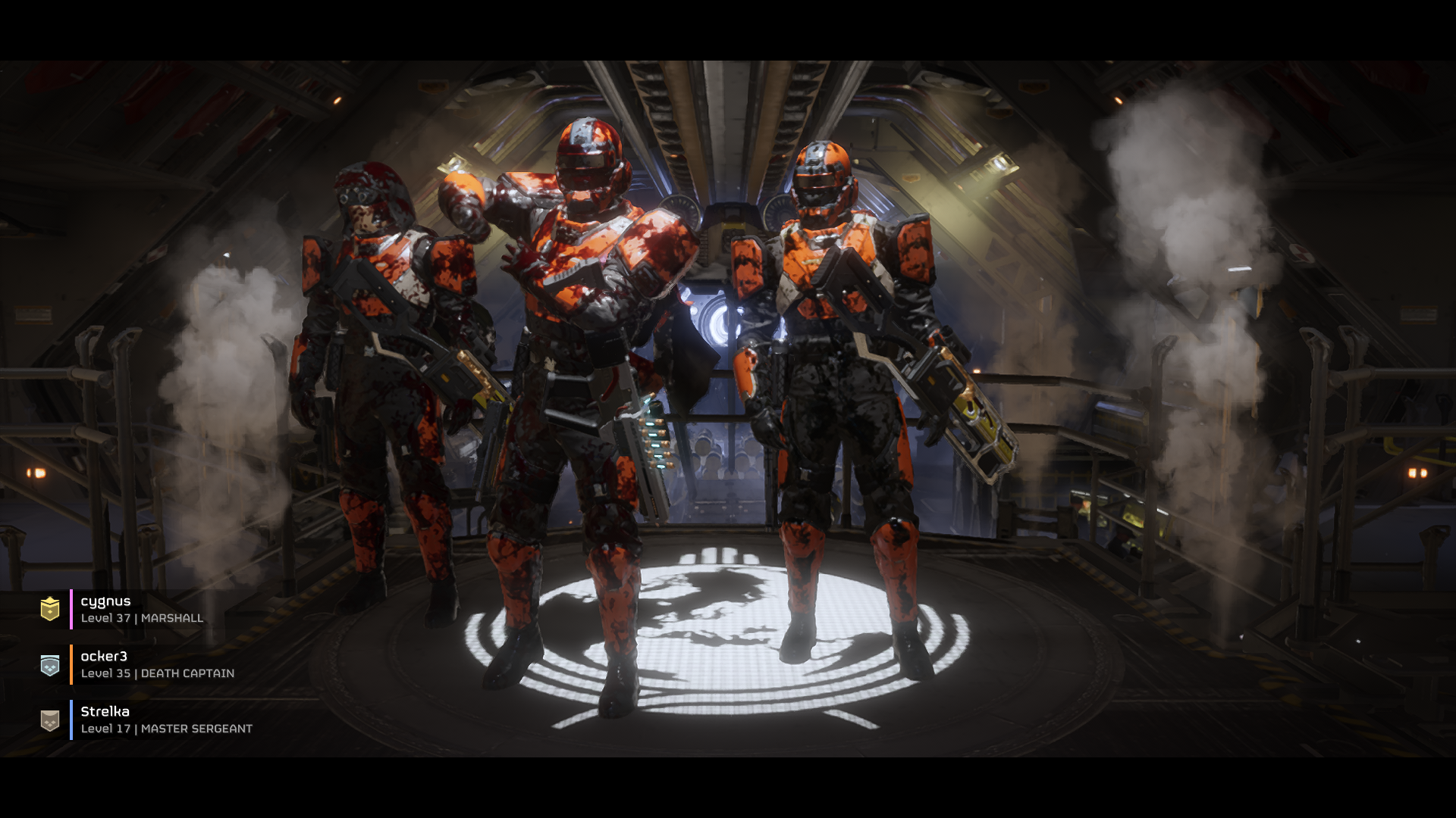 Three helmeted squad members in orange and dark armour pose aboard a spacecraft, with steam rising beside them.