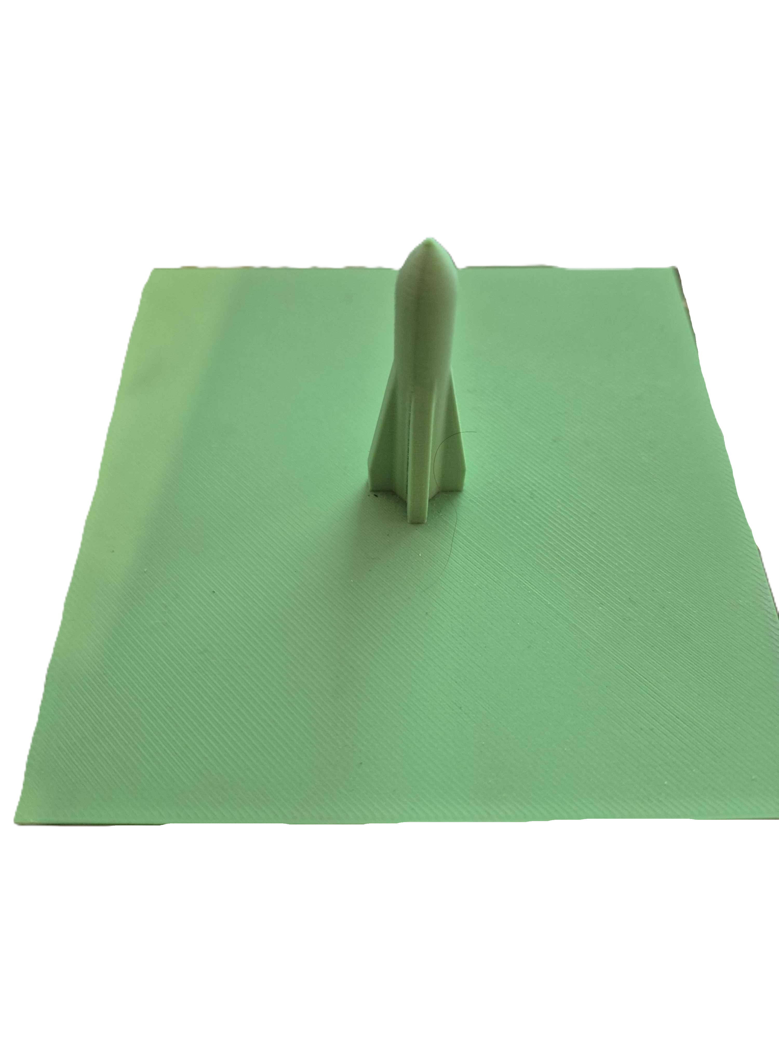 A green spike on a square base used to dispose of sticky notes