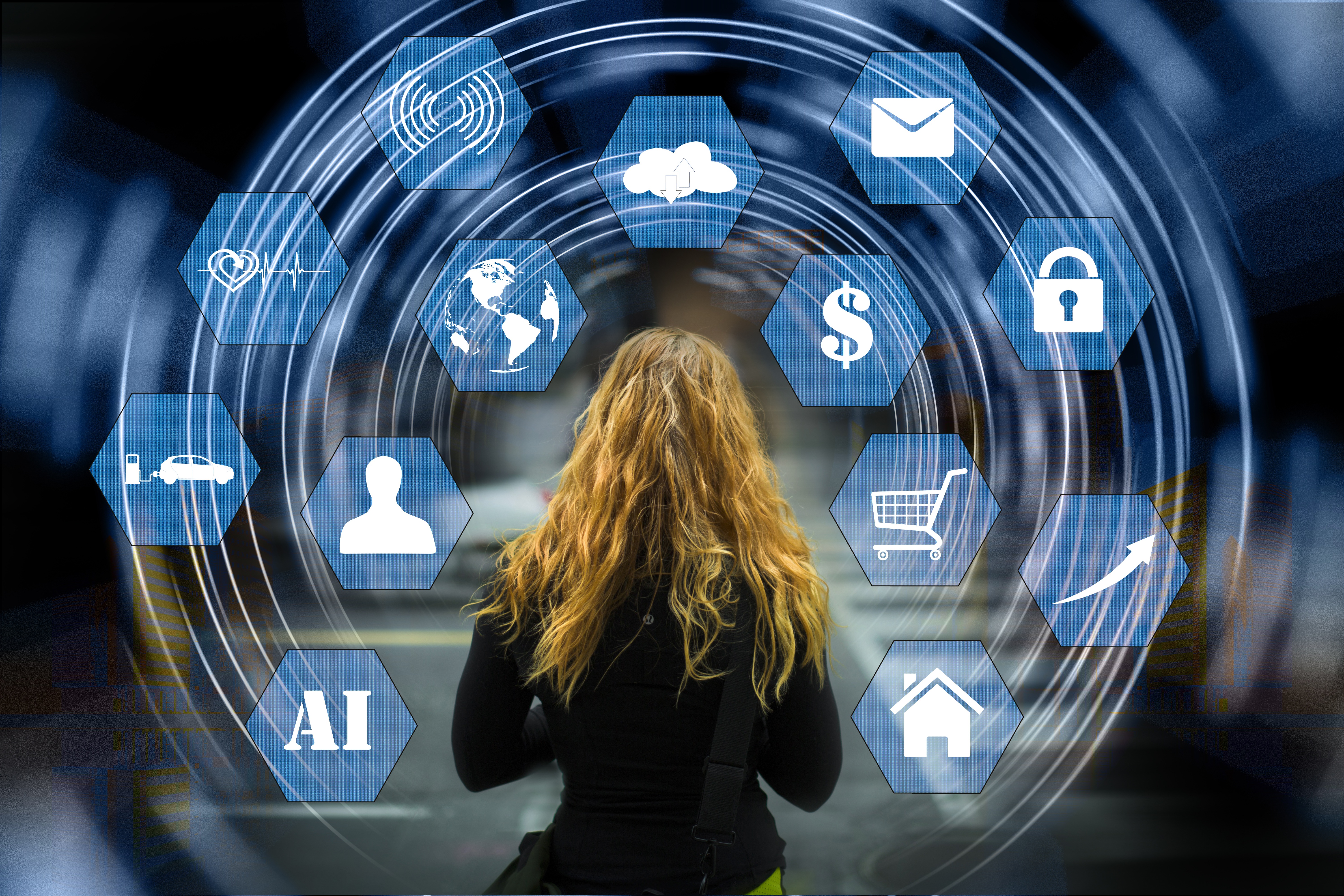 A woman with long blond hair in rear view, studying a projection of internet options in hexagonal windows
