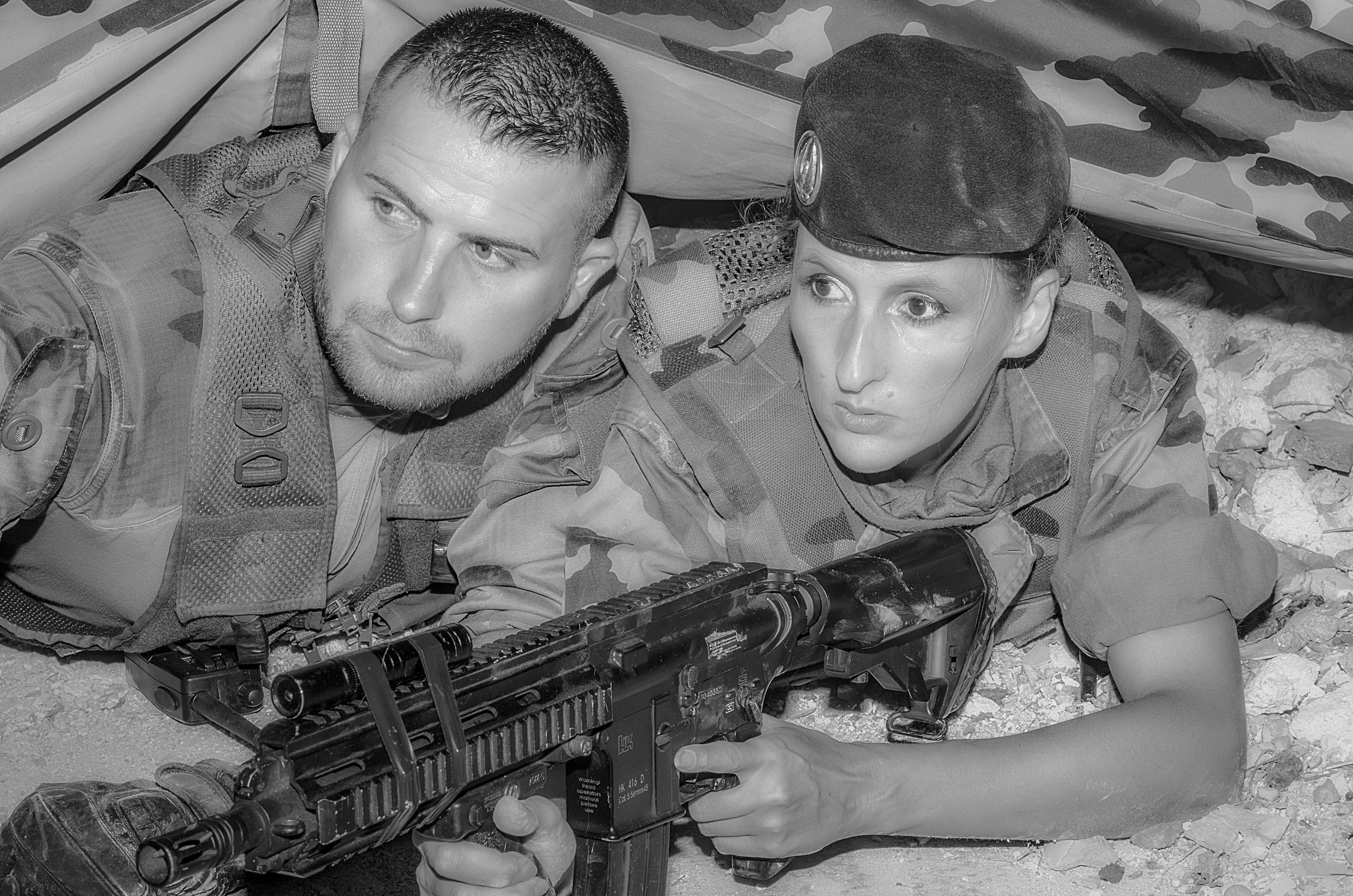 military trainer.jpg An older soldier giving instruction to a younger soldier in a firing exercise in grayscale
