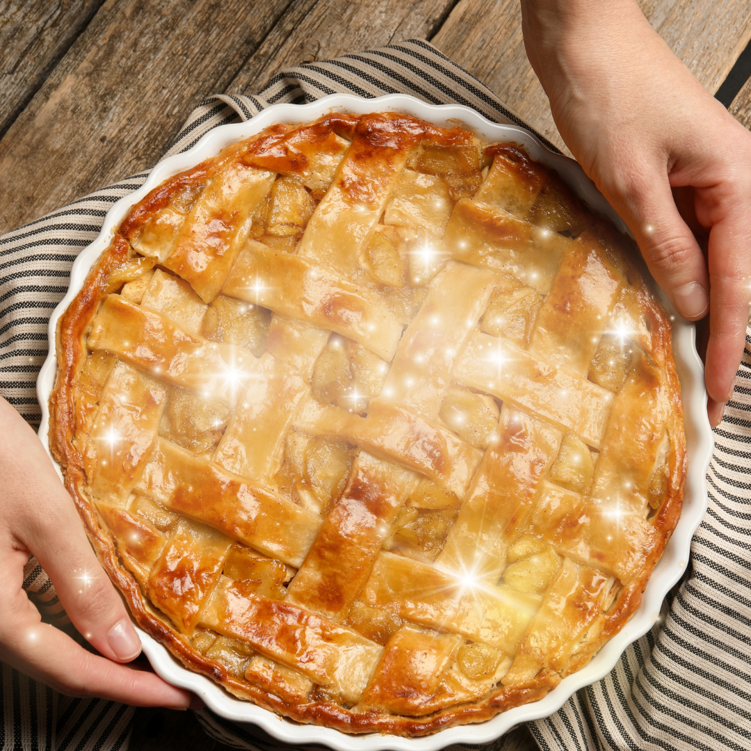 An inviting apple pie being set on a wooden table, sparkling with magic