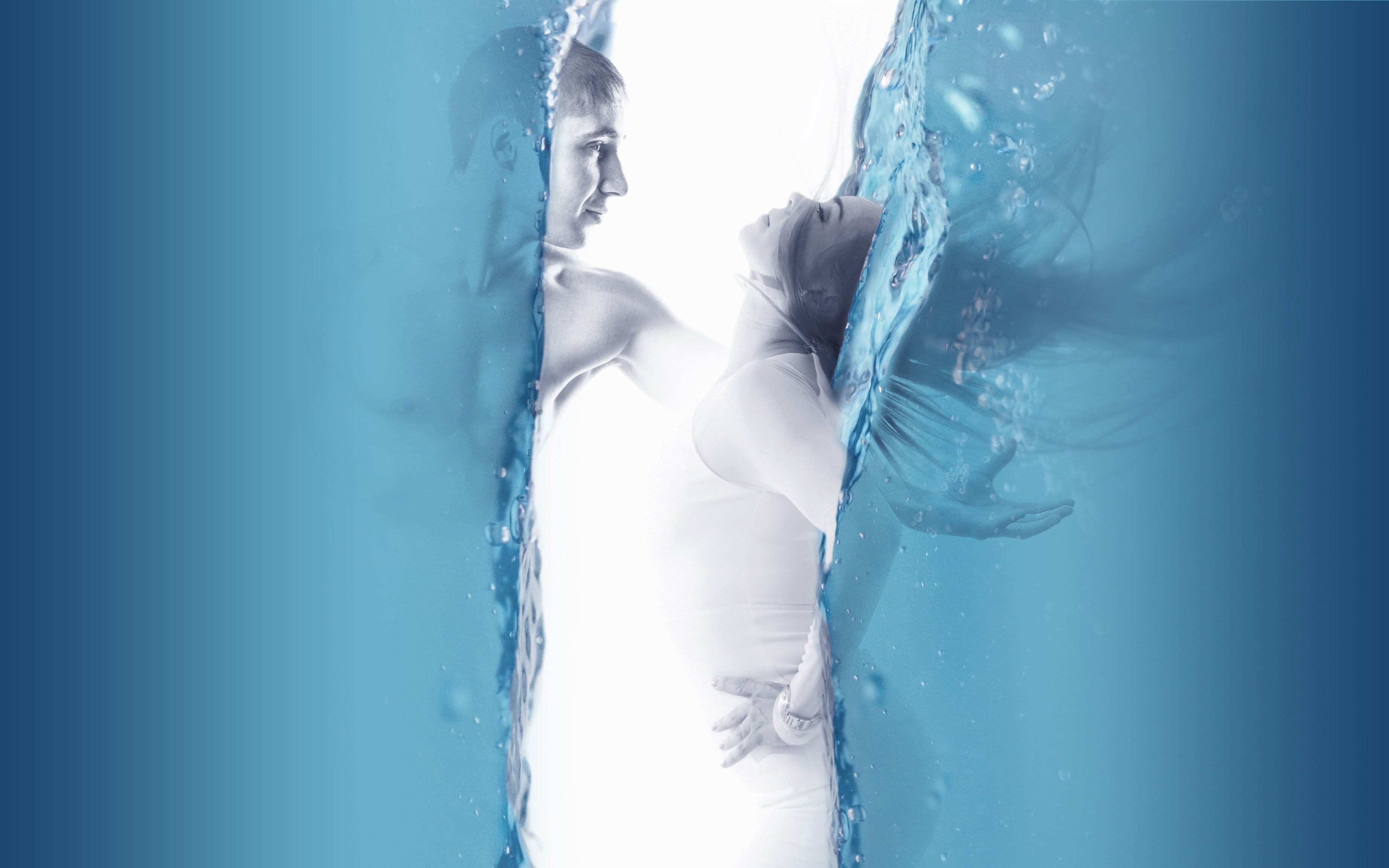 Two columns of water, with a man in one of them, reaching out to pull a woman out of the other. The people are in greyscale.