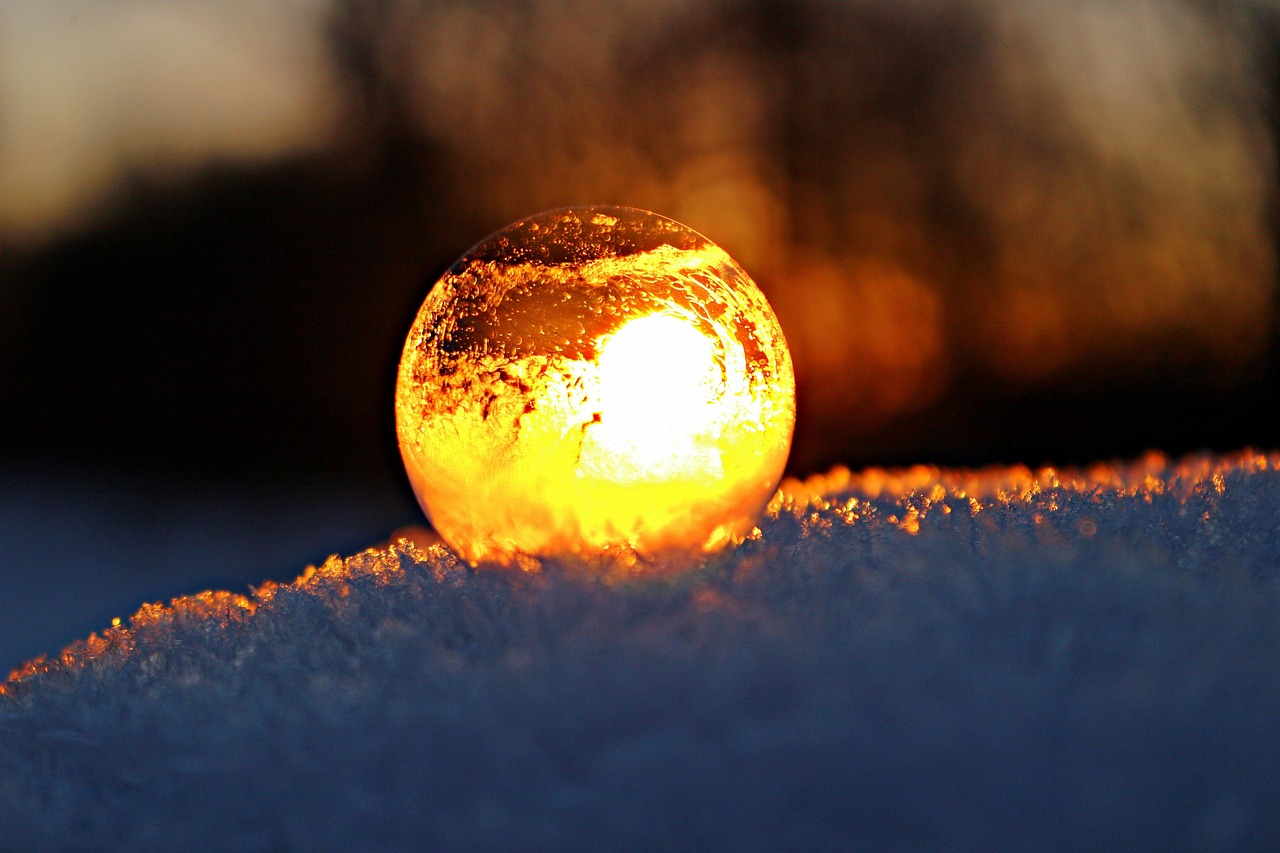 A glowing round crystal on snow