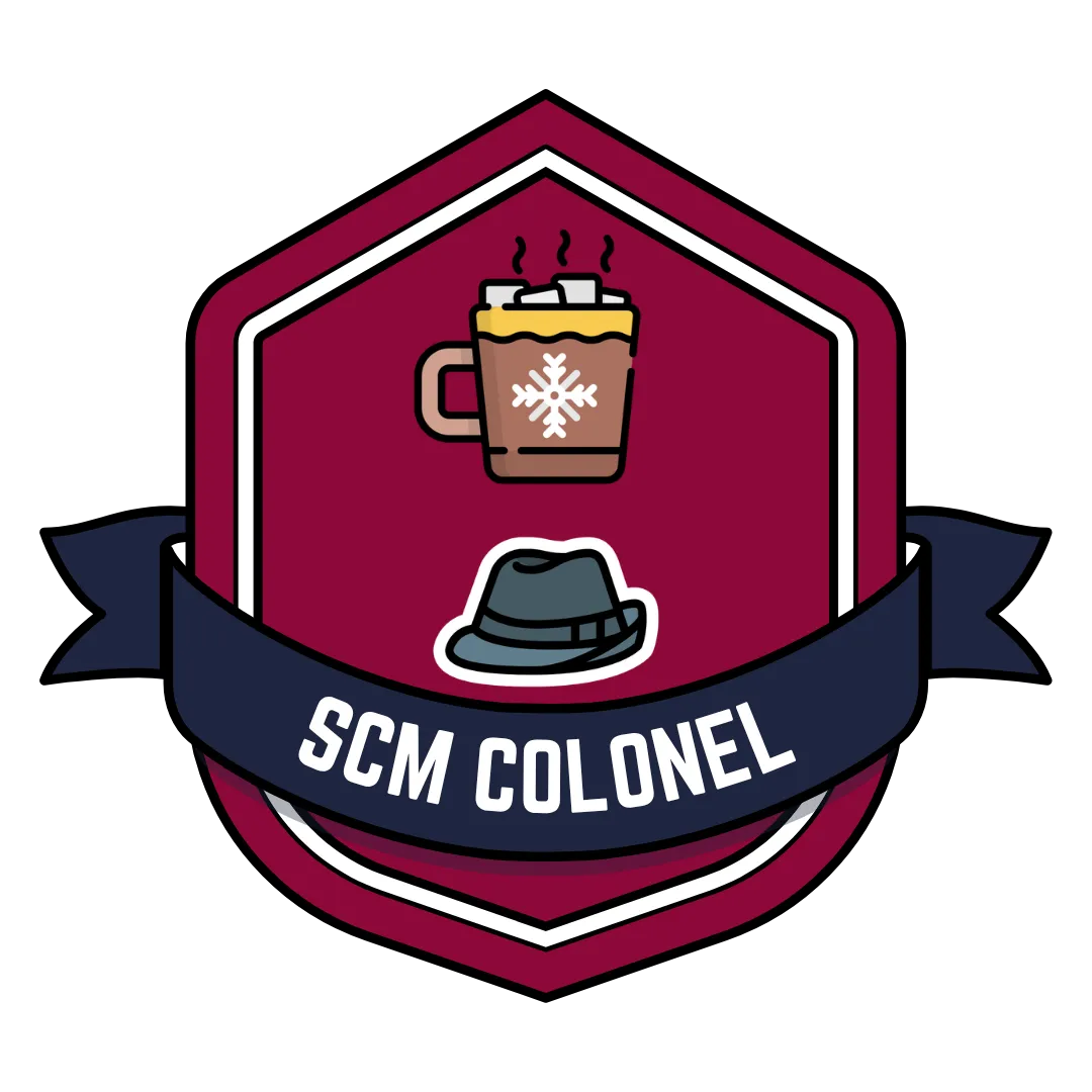 Red badge with fedora, gold star, cocoa, and blue ribbon that says SCM Colonel.